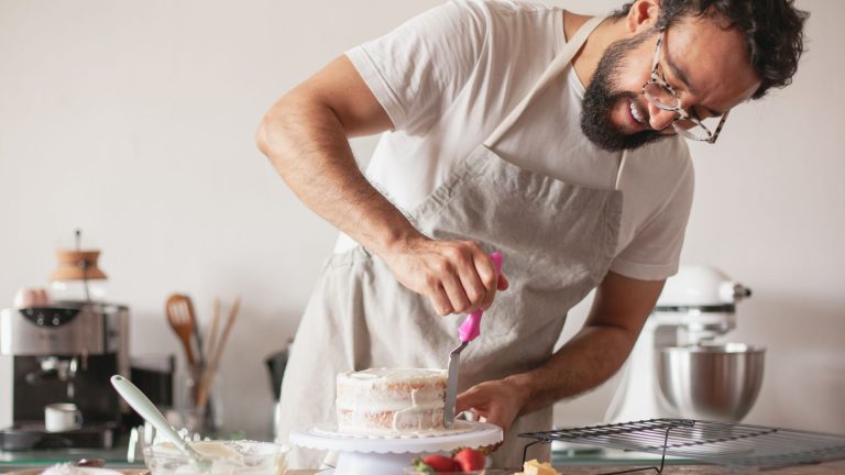 A Baker Making a Cake in a Kitchen