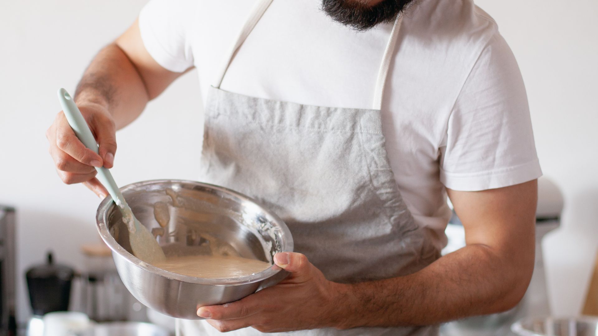 A Baker Pouring Batter into a Baking Pan