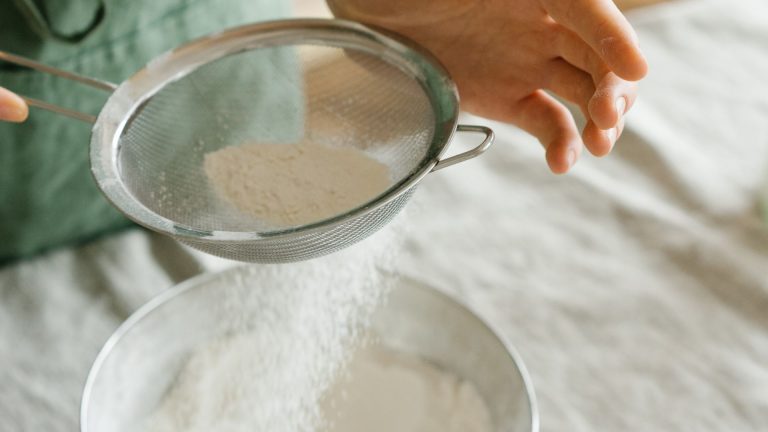 A Baker Sifting Flour