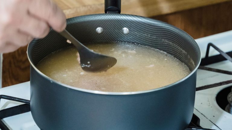 A Person Cooking a Soup Dish