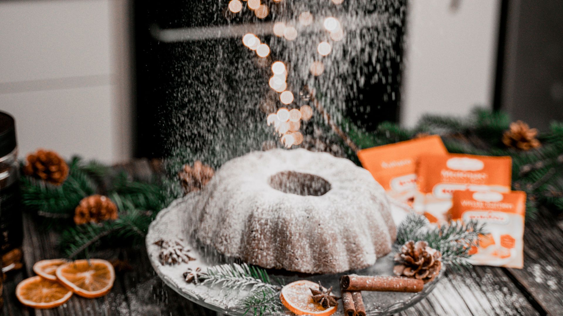 A Person Dusting Powdered Sugar on a Cake