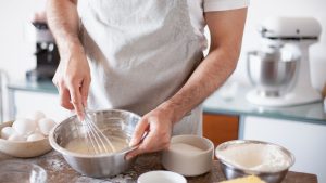 A Person Mixing a Batter using a Wire Whisk