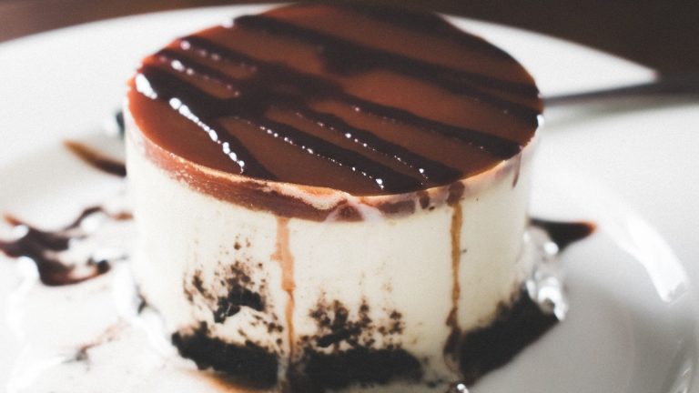 Black, Brown, and White Melted Cake on Round White Ceramic Plate