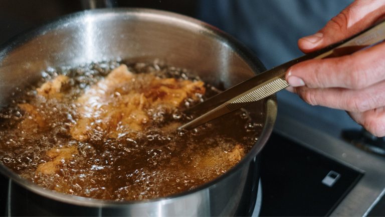 Person Holding Stainless Steel Cooking Pot