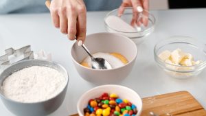 Person Mixing Yellow Eggs in a Bowl