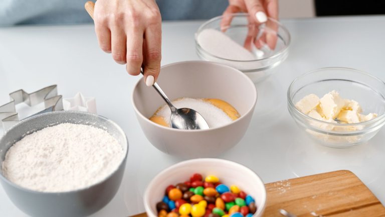 Person Mixing Yellow Eggs in a Bowl