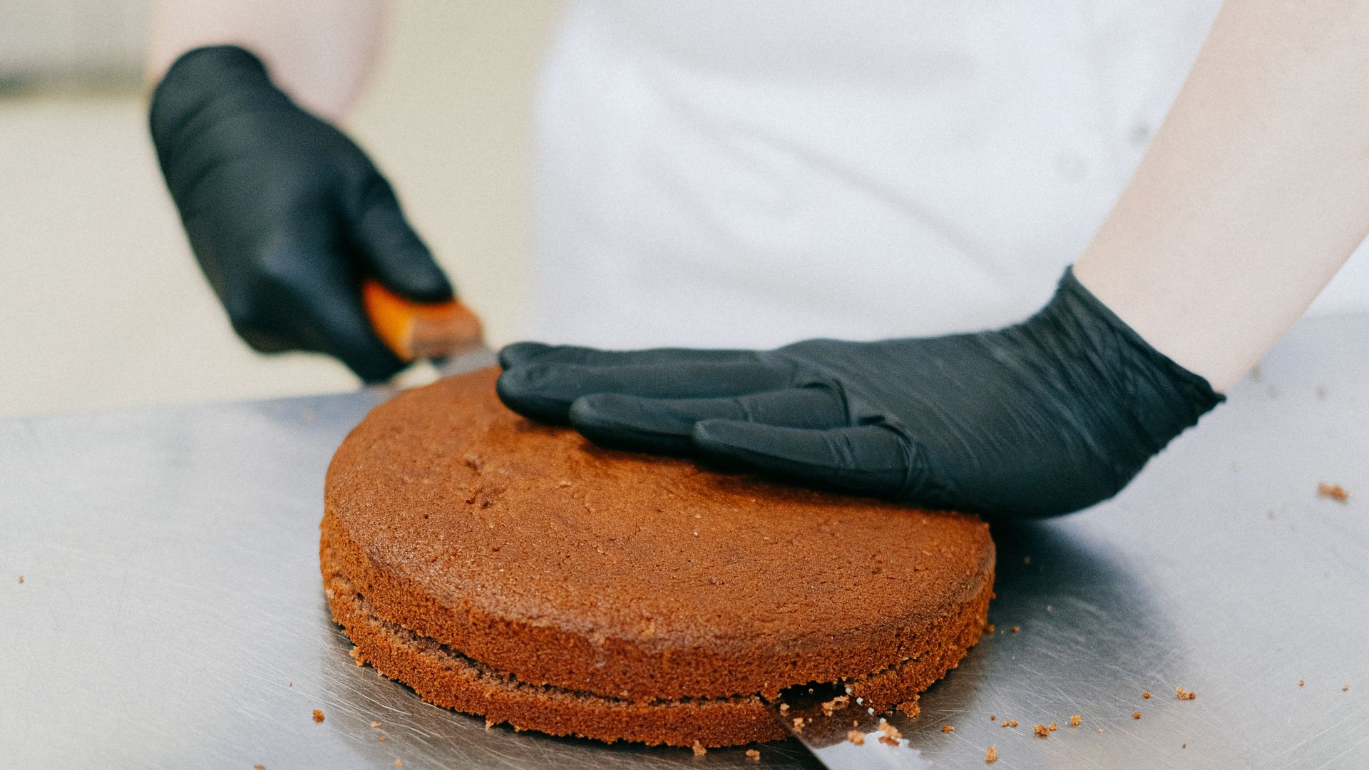 Person Slicing a Cake