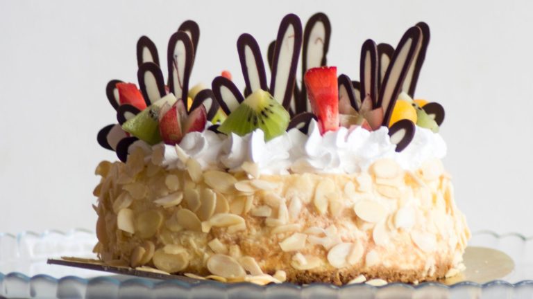 Photo of Brown and White Icing Covered Cake With Kiwi