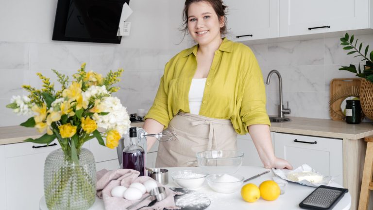 Smiling Homemaker with Cooking Ingredients on Table