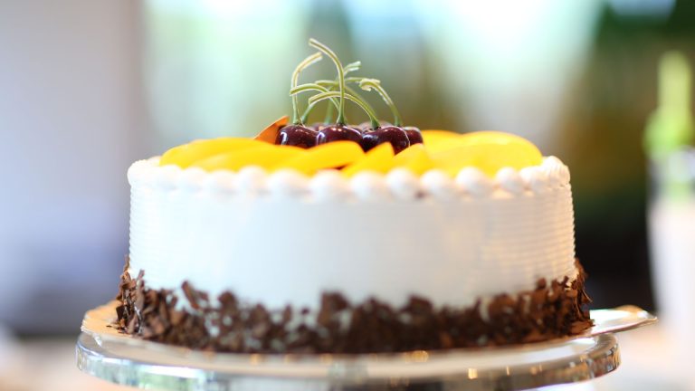 White Round Cake Topped With Yellow Slice Fruit