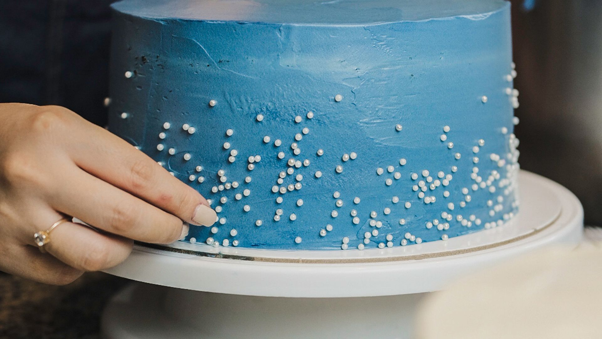 Woman Hand on Blue Cake,,.