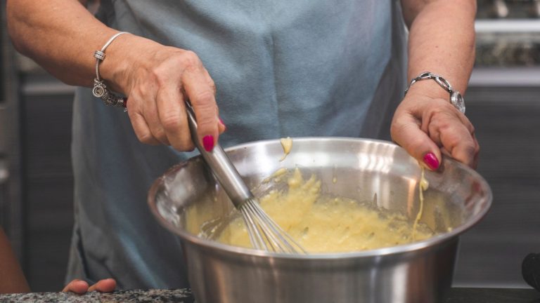 Woman in Pink Shirt Holding Stainless Bowl and Whisker