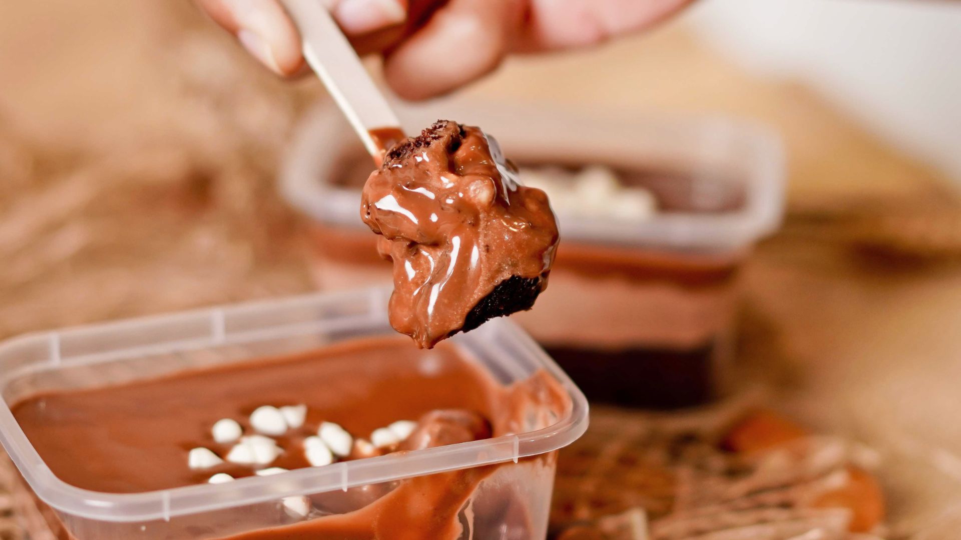 person adding chocolate to cake