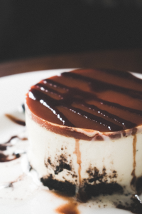 Black, Brown, and White Melted Cake on Round White Ceramic Plate