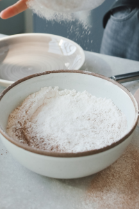 A Baker Sifting Flour