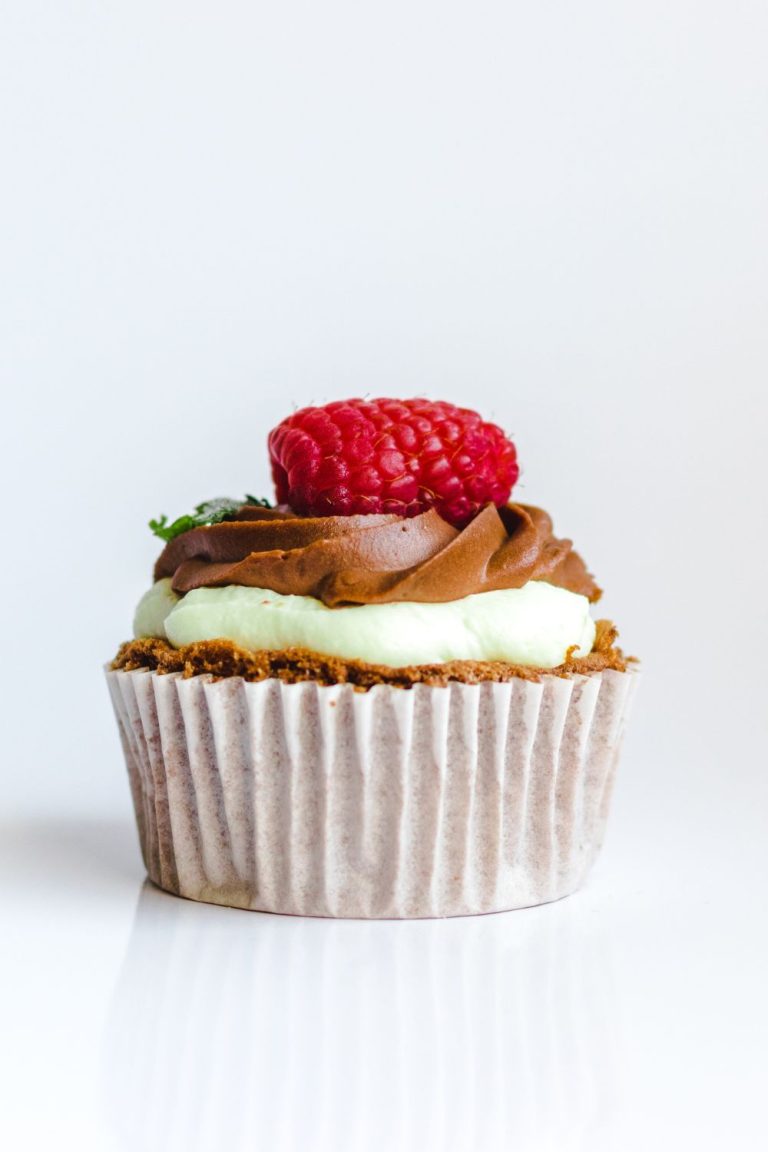 Photograph of Chocolate Cupcake With Red Strawberry Toppings